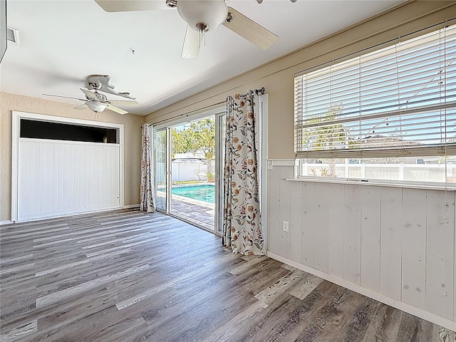 unfurnished room featuring wood finished floors and ceiling fan