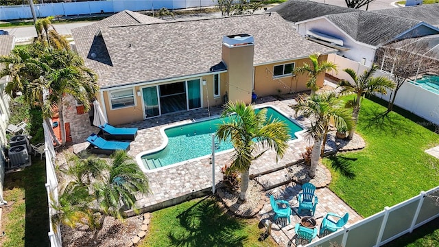 view of swimming pool featuring a patio area, a yard, a fenced backyard, and a fenced in pool