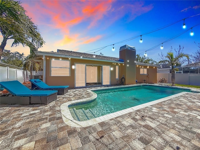 view of swimming pool with a patio, fence, and a fenced in pool