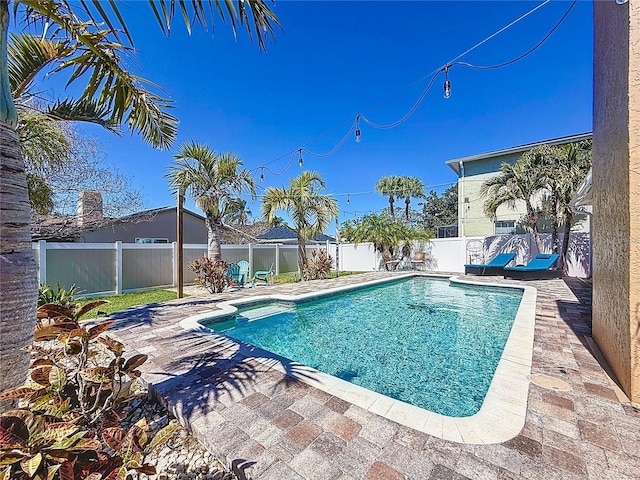 view of pool featuring a fenced in pool, a patio, and a fenced backyard