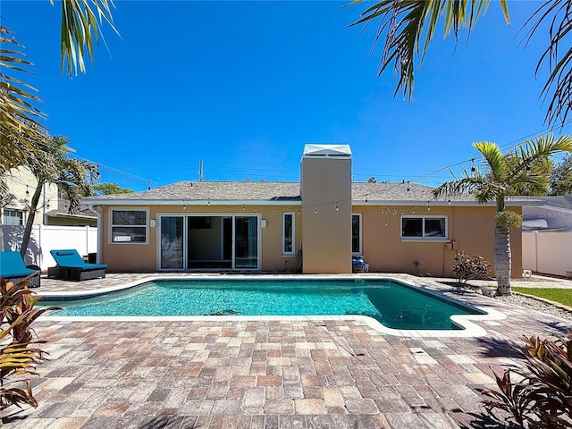 view of swimming pool with a fenced in pool, a patio, and fence