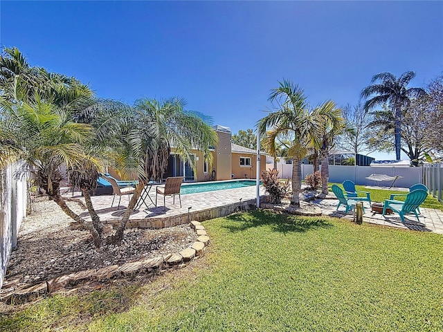 view of yard featuring a patio area, a fenced in pool, and a fenced backyard