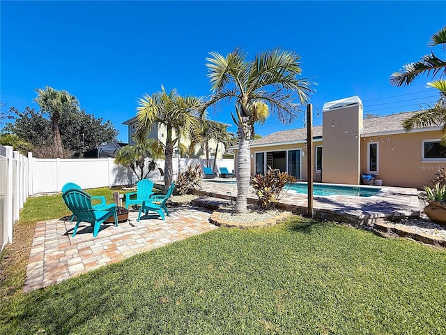 view of yard featuring a patio area, a fenced in pool, and a fenced backyard