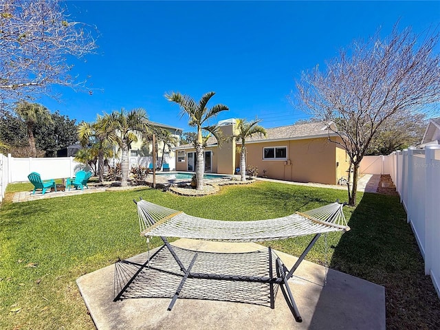 view of yard featuring a patio area, a fenced in pool, and a fenced backyard