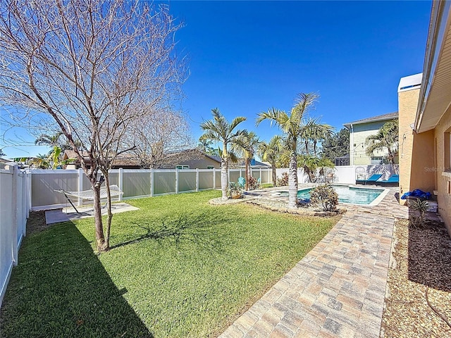 view of yard with a fenced in pool, a patio, and a fenced backyard