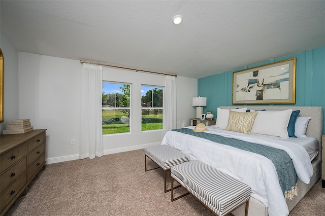 bedroom featuring baseboards, carpet floors, and a textured ceiling