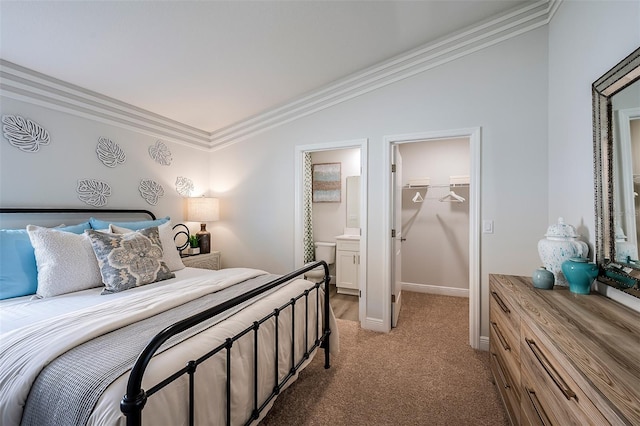 bedroom featuring a spacious closet, crown molding, baseboards, light colored carpet, and vaulted ceiling