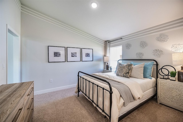 bedroom featuring baseboards, crown molding, lofted ceiling, and carpet floors