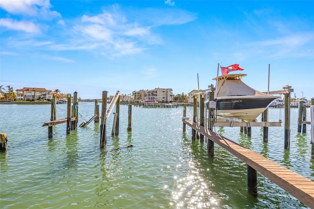 dock area featuring boat lift and a water view