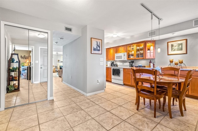 dining room featuring light tile patterned floors, baseboards, and visible vents