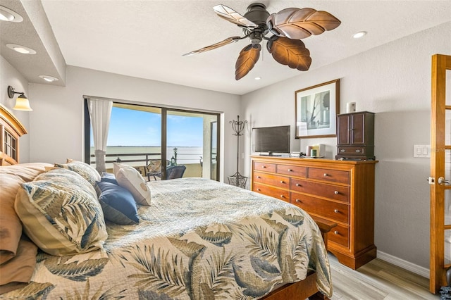 bedroom featuring light wood finished floors, ceiling fan, baseboards, recessed lighting, and access to outside