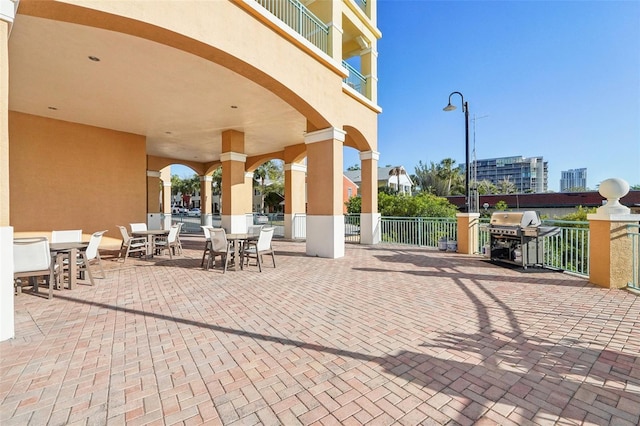 view of patio / terrace featuring area for grilling, outdoor dining space, and fence