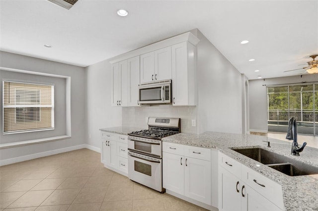 kitchen with plenty of natural light, backsplash, stainless steel appliances, and a sink