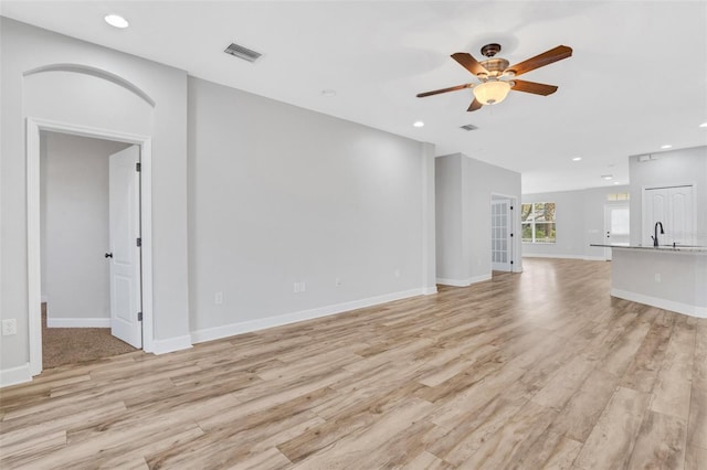 unfurnished living room with light wood-style flooring, recessed lighting, a ceiling fan, and visible vents