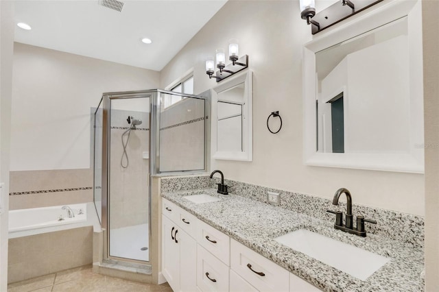 bathroom featuring a sink, a garden tub, and a shower stall