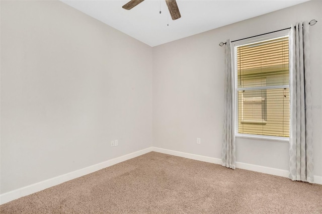 spare room featuring baseboards, carpet, and a ceiling fan