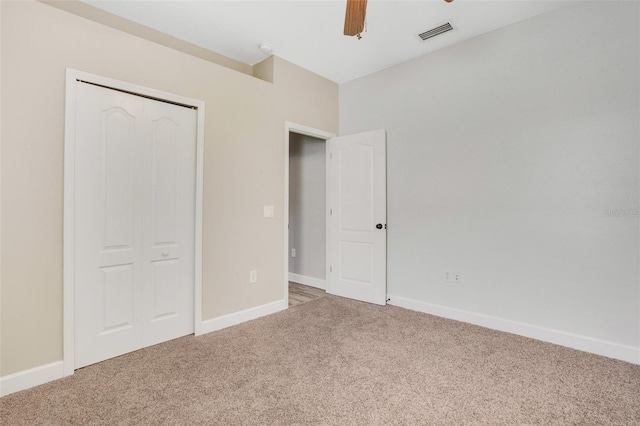 unfurnished bedroom featuring visible vents, baseboards, and carpet