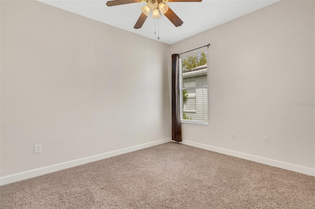 spare room featuring ceiling fan, baseboards, and carpet floors