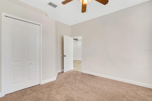 unfurnished bedroom with ceiling fan, carpet, visible vents, and baseboards