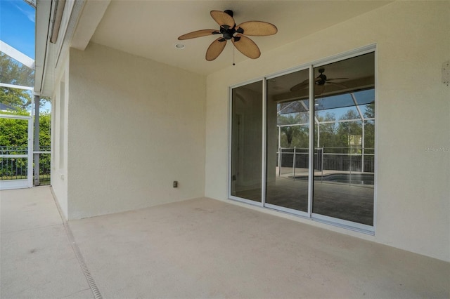 view of patio / terrace with glass enclosure and ceiling fan