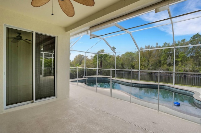 view of swimming pool with a fenced in pool, glass enclosure, a patio, and fence