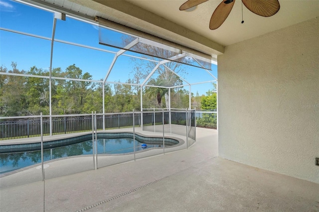 view of pool featuring a fenced in pool, ceiling fan, fence, glass enclosure, and a patio