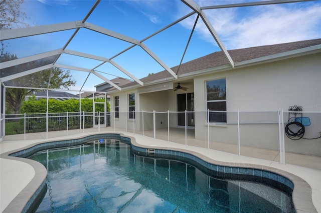 view of pool featuring a patio area, a fenced in pool, glass enclosure, and a ceiling fan