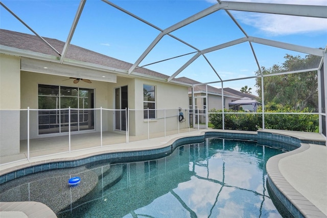 pool featuring a lanai, a patio area, and ceiling fan