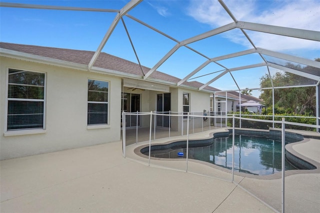 pool with a lanai, a patio area, and ceiling fan