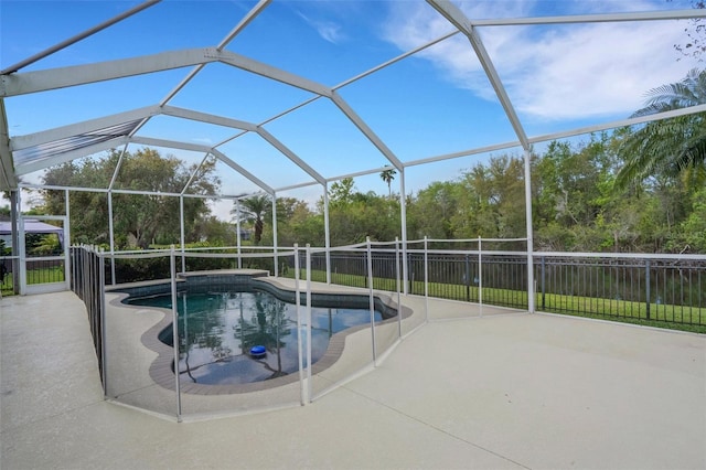 view of pool featuring a patio area, fence, a fenced in pool, and a lanai