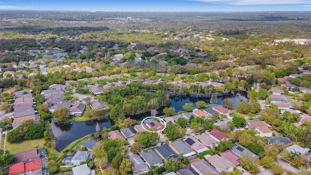 drone / aerial view featuring a residential view and a water view