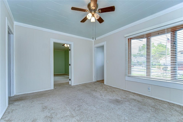 unfurnished room featuring carpet, a ceiling fan, and ornamental molding