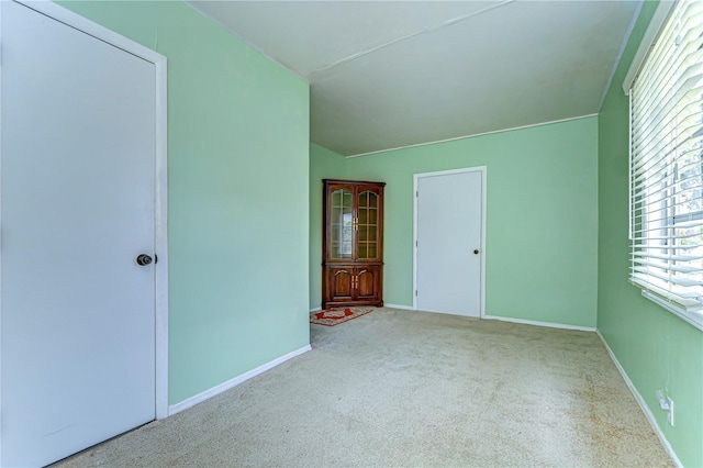 unfurnished bedroom featuring carpet flooring and baseboards