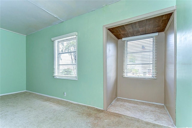 unfurnished room with a wealth of natural light and carpet floors