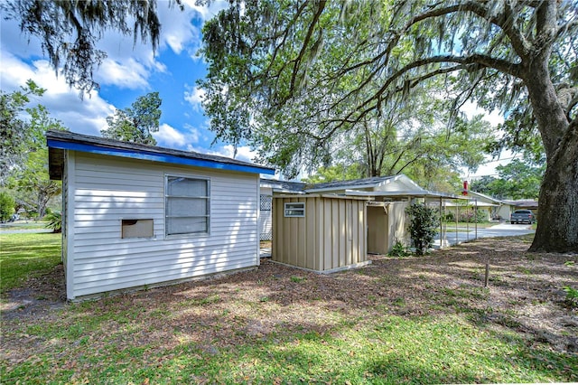 back of property featuring a shed and an outdoor structure