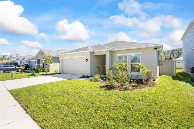 view of front of property featuring a front yard, a garage, driveway, and stucco siding