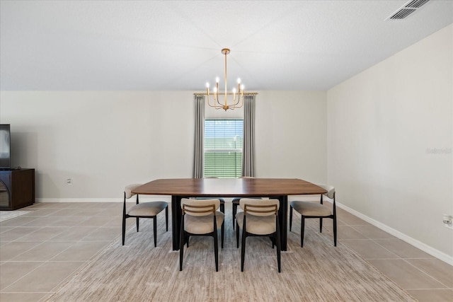 dining area with light tile patterned floors, visible vents, baseboards, and an inviting chandelier