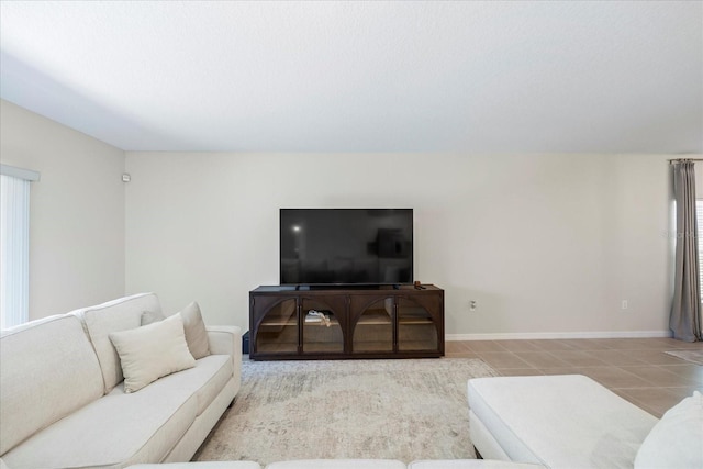 tiled living area with baseboards