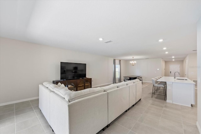 living area featuring visible vents, a notable chandelier, recessed lighting, light tile patterned floors, and baseboards