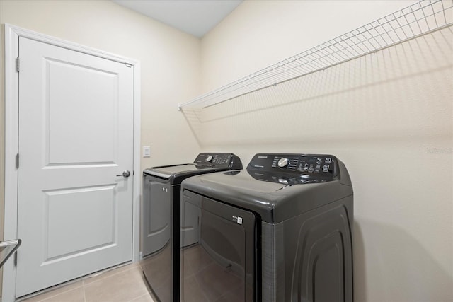 laundry area with light tile patterned floors, laundry area, and separate washer and dryer