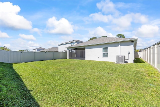 view of yard with cooling unit, a fenced backyard, and a sunroom