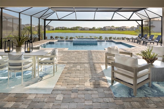 view of pool featuring a water view, a patio, a lanai, and a pool with connected hot tub