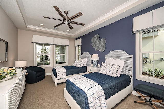 carpeted bedroom featuring recessed lighting, a tray ceiling, a textured ceiling, and a ceiling fan