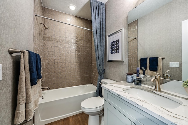 bathroom featuring toilet, shower / bath combo, a textured ceiling, wood finished floors, and vanity