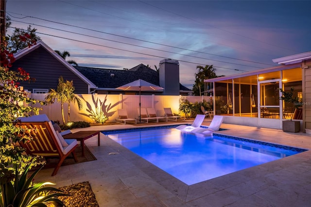 view of pool with a fenced in pool, a patio, a fenced backyard, and a sunroom