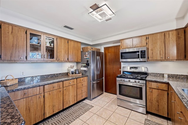 kitchen featuring visible vents, brown cabinets, and appliances with stainless steel finishes