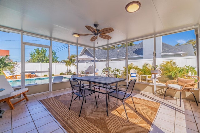 sunroom / solarium with a ceiling fan