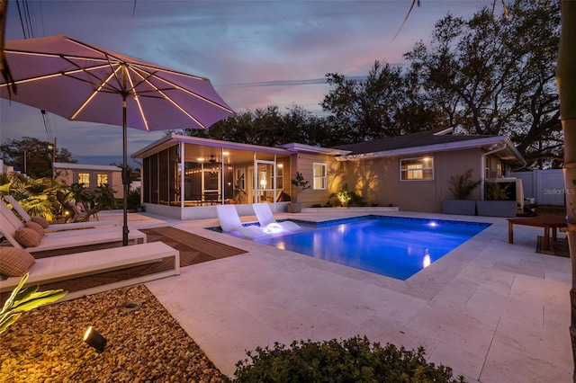 pool featuring a patio and a sunroom