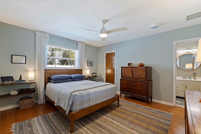 bedroom with visible vents, a ceiling fan, baseboards, and wood finished floors