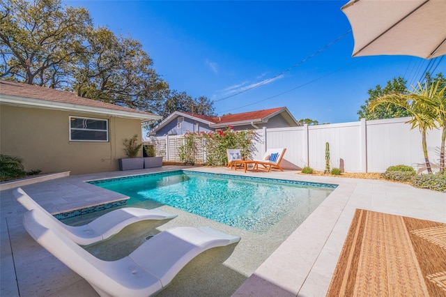 view of pool with a patio area, a fenced in pool, and fence